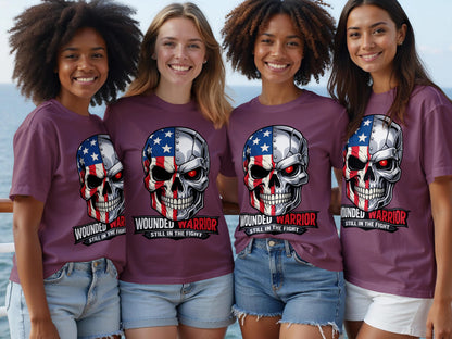 Four women wear purple t-shirts with a skull graphic and text "WOUNDED WARRIOR STILL IN THE FIGHT".