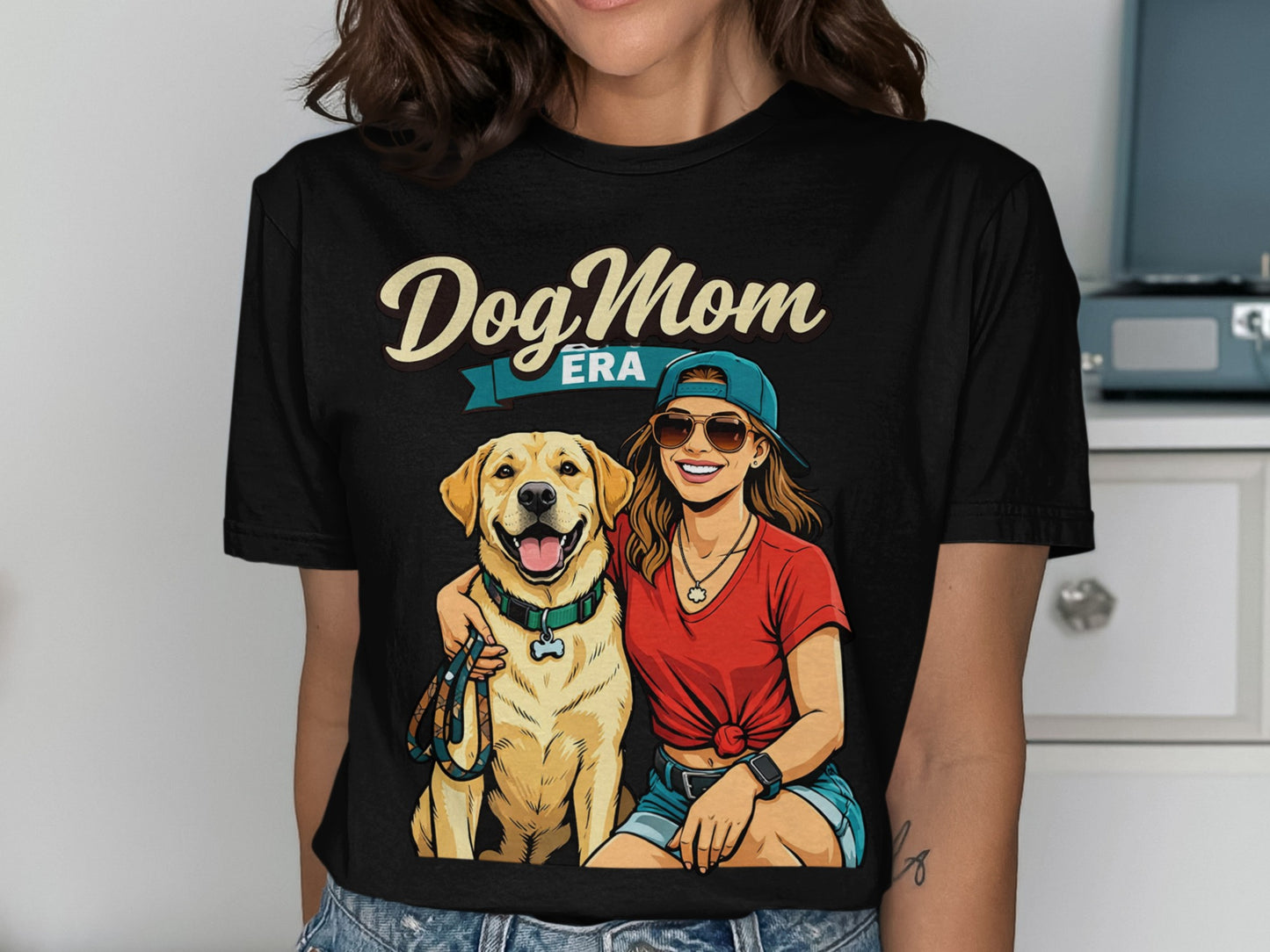 Dog Mom Era graphic on black t-shirt featuring a woman and a golden retriever.