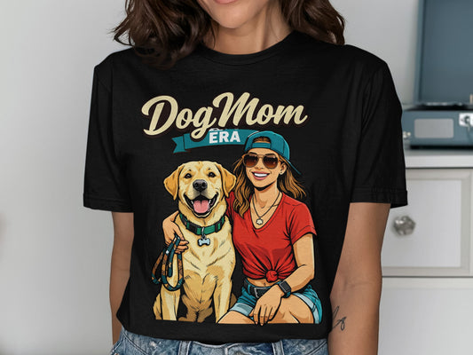 Dog Mom Era graphic on black t-shirt featuring a woman and a golden retriever.