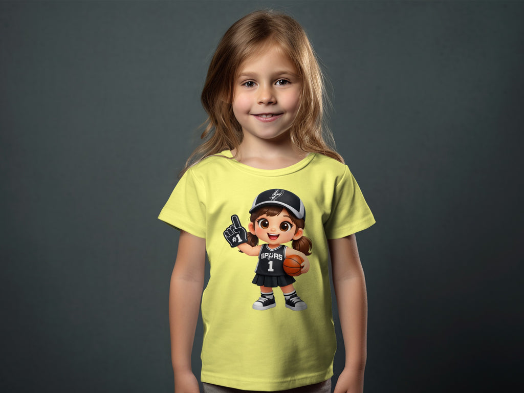Child modeling a yellow shirt with a cartoon graphic reading "SPURS 1".