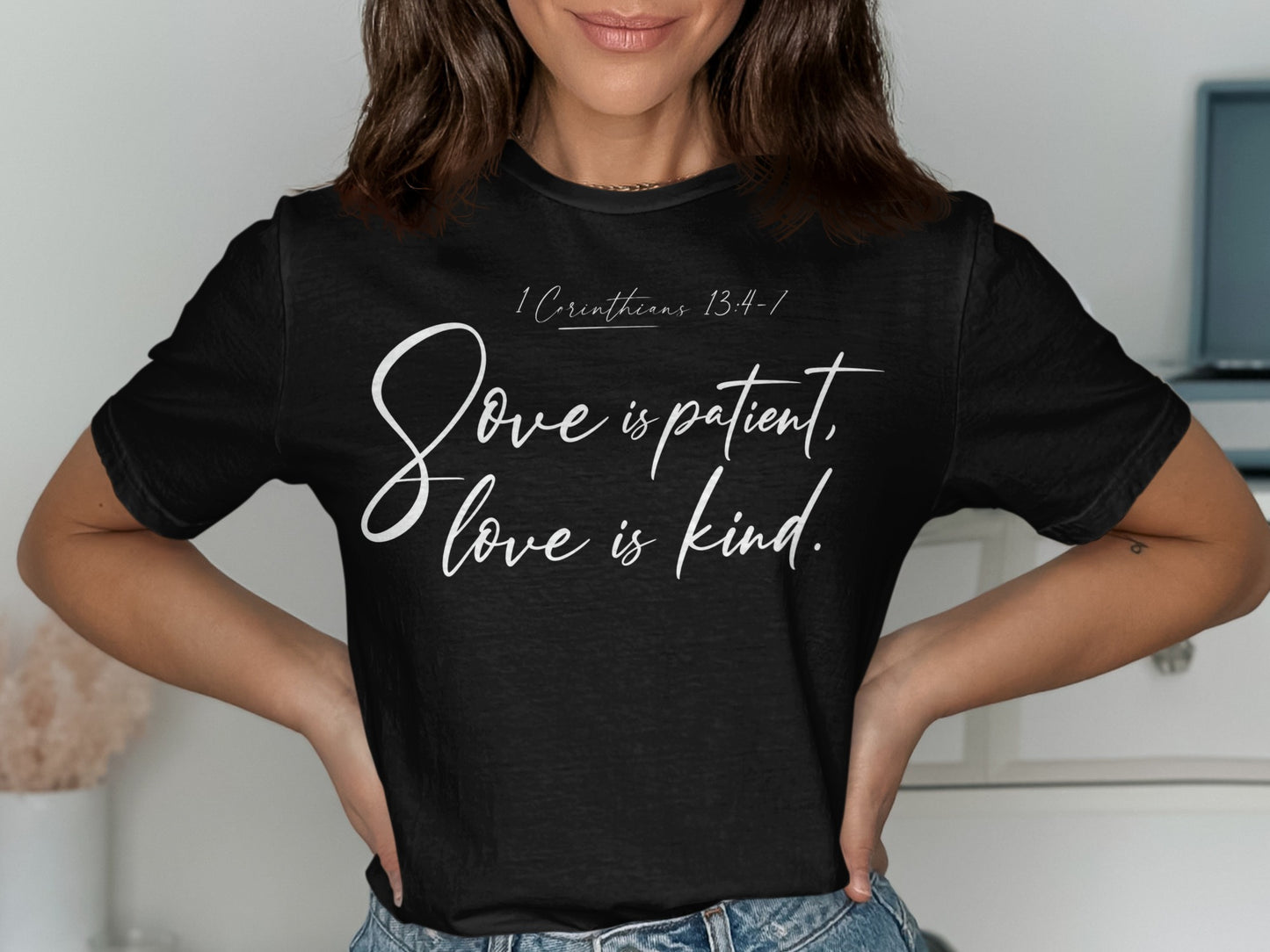 Black t-shirt with white text: "1 Corinthians 13:4-7, Love is patient, love is kind."