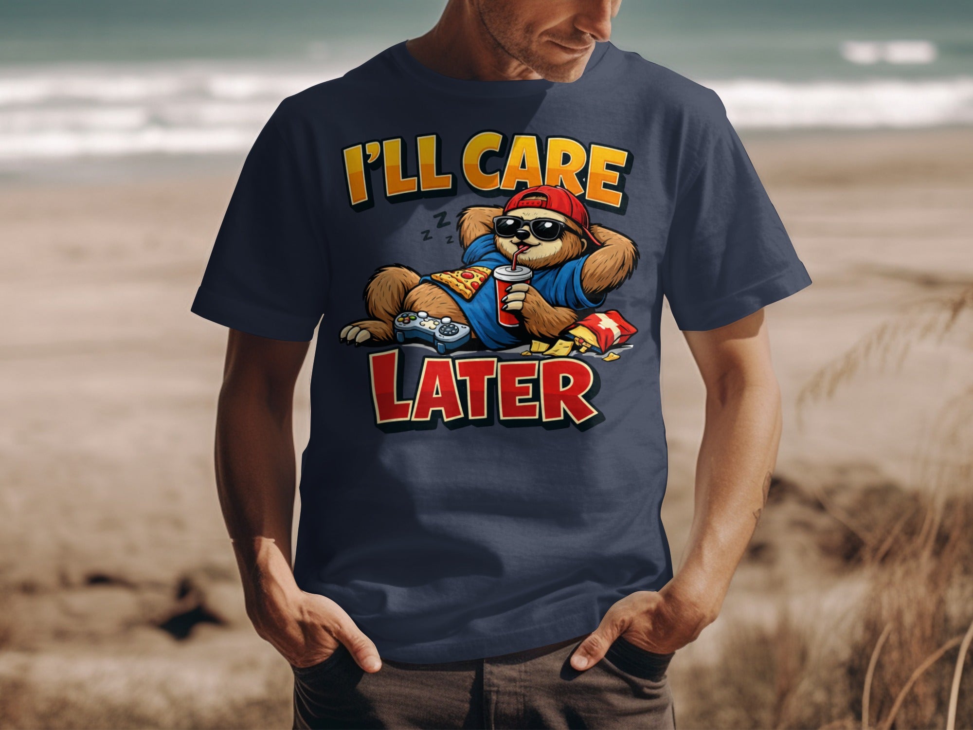 Navy t-shirt with cartoon sloth holding pizza, drink, and game controller, text "I'll Care Later".