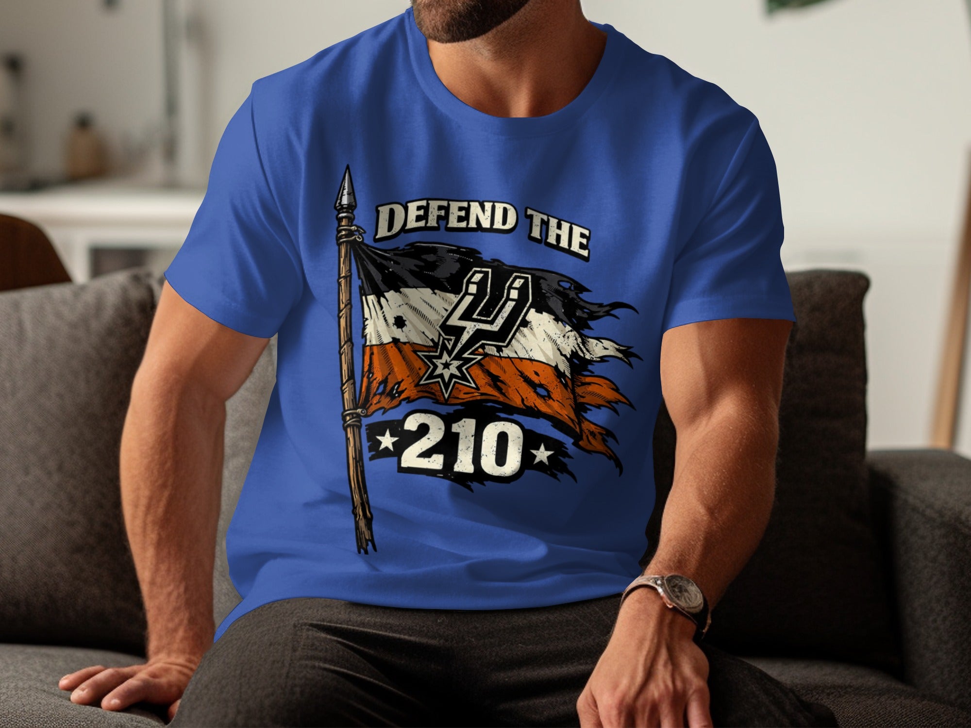 Torn flag with Spurs logo, text "DEFEND THE 210", on a blue t-shirt.
