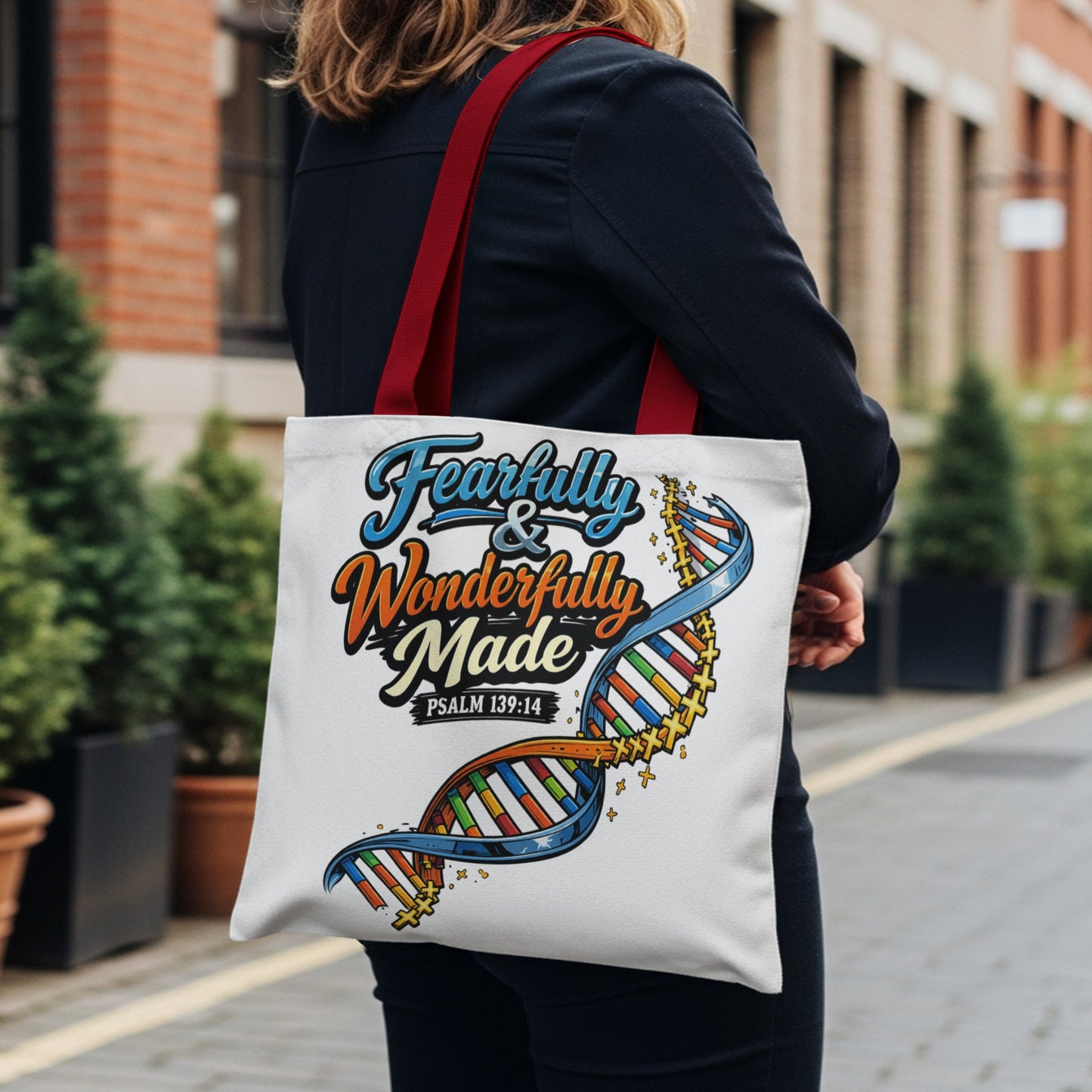White tote bag with "Fearfully & Wonderfully Made" text and DNA graphic.