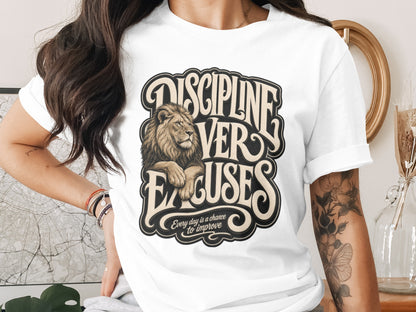 White t-shirt with "DISCIPLINE VER EXCUSES" text and a lion graphic.