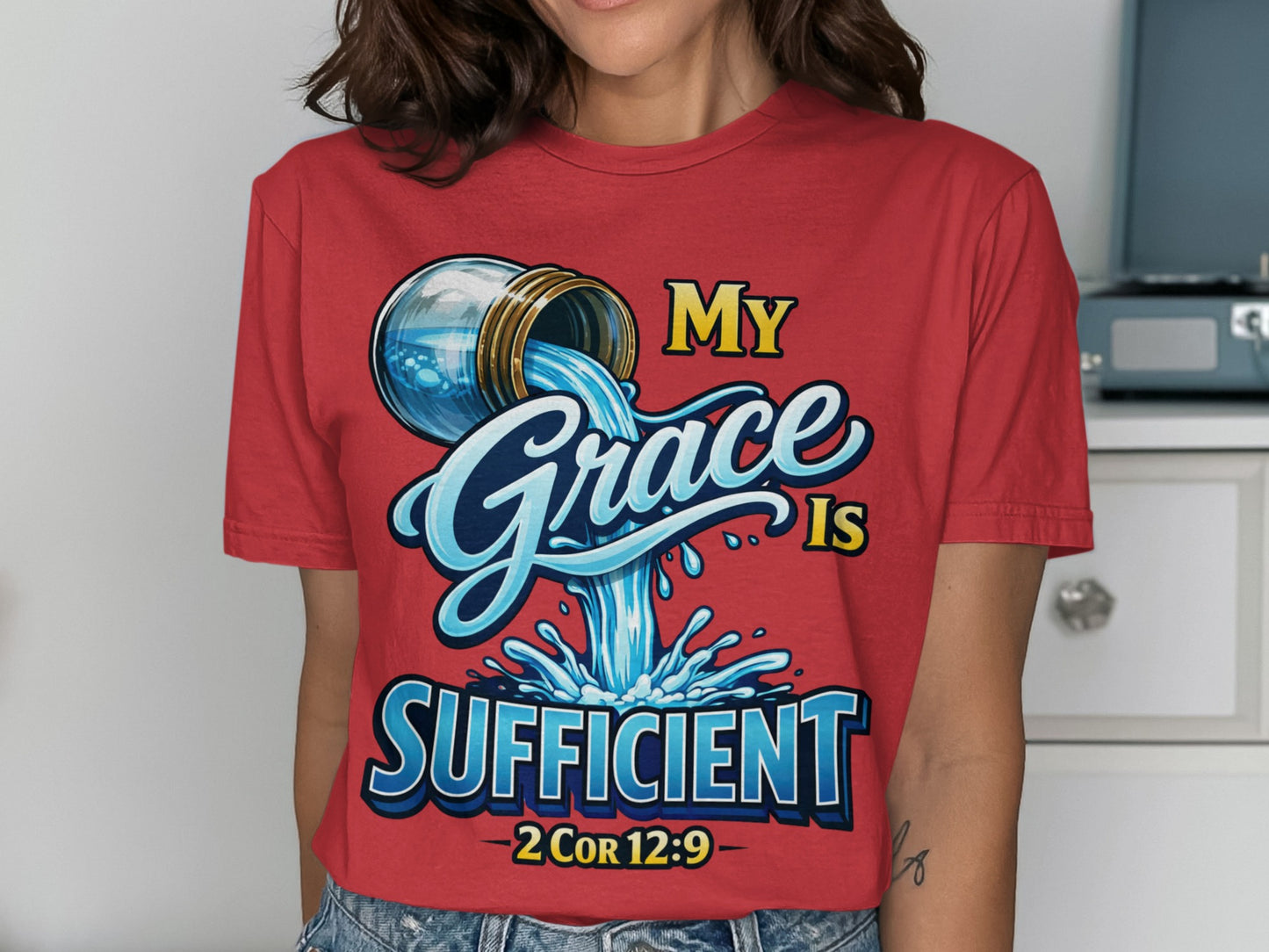 Red t-shirt with "My Grace Is Sufficient - 2 Cor 12:9" text and water pouring from a jug.