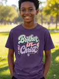 Young boy smiling in purple t-shirt with "Brother in Christ" text.