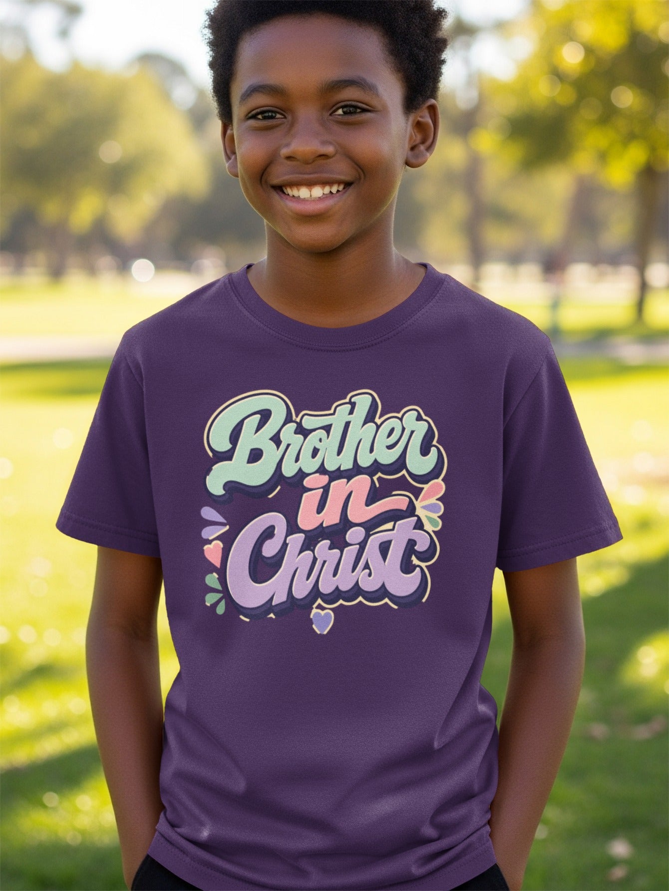 Young boy smiling in purple t-shirt with "Brother in Christ" text.