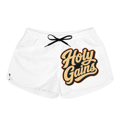White athletic shorts with "Holy Gains" text graphic and black drawstring.