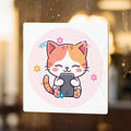 Cute cartoon kitten holding a smartphone, decorated with flowers and confetti.
