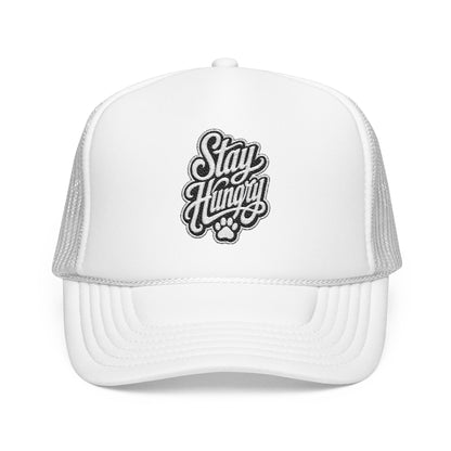 White trucker hat with "Stay Hungry" embroidered logo and paw print.