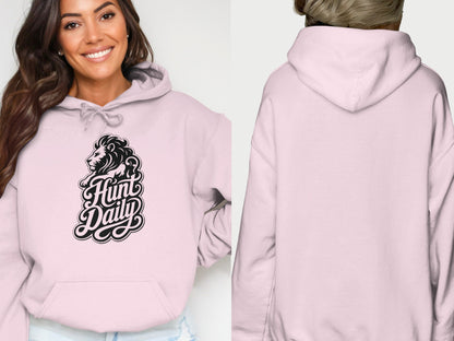 Pink hoodie with lion and text "Hunt Daily" graphic on front.