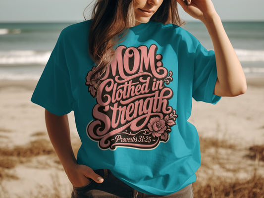 Teal t-shirt with "MOM: Clothed in Strength - Proverbs 31:25" text design.