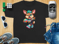 Cartoon fox mascot in athletic gear holding a basketball on a black t-shirt.