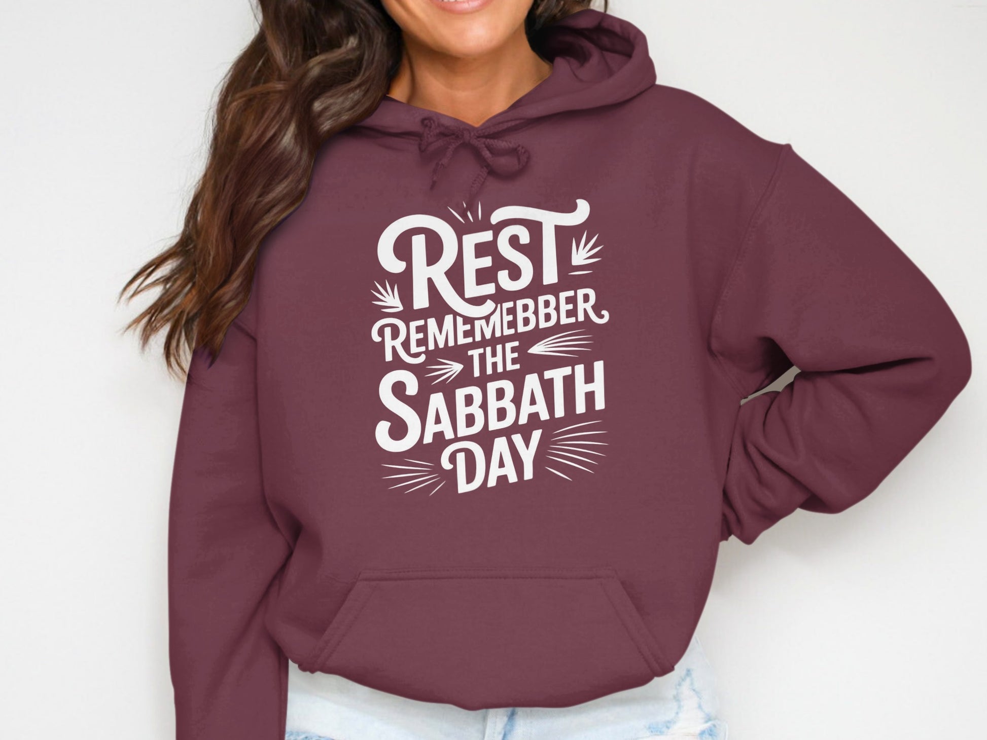 Burgundy hoodie with white text "REST REMEMBER THE SABBATH DAY"