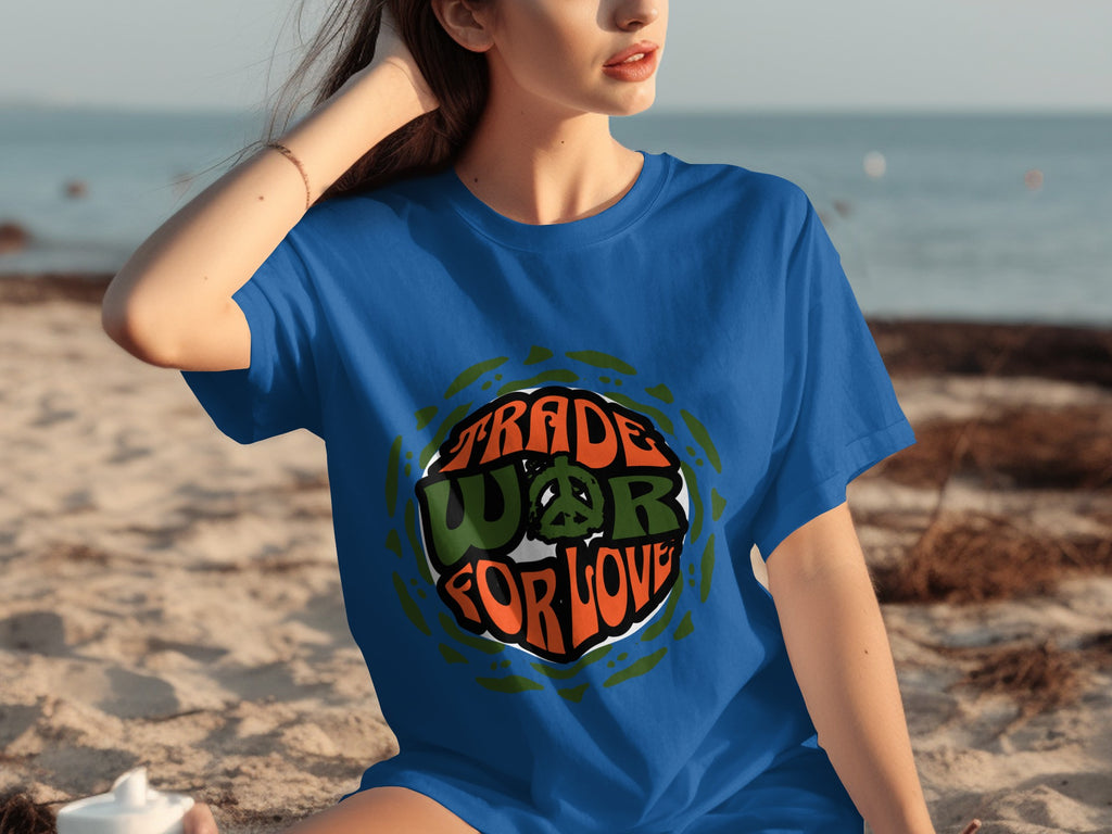 Blue t-shirt with "TRADE WAR FOR LOVE" and peace sign graphic on beach background