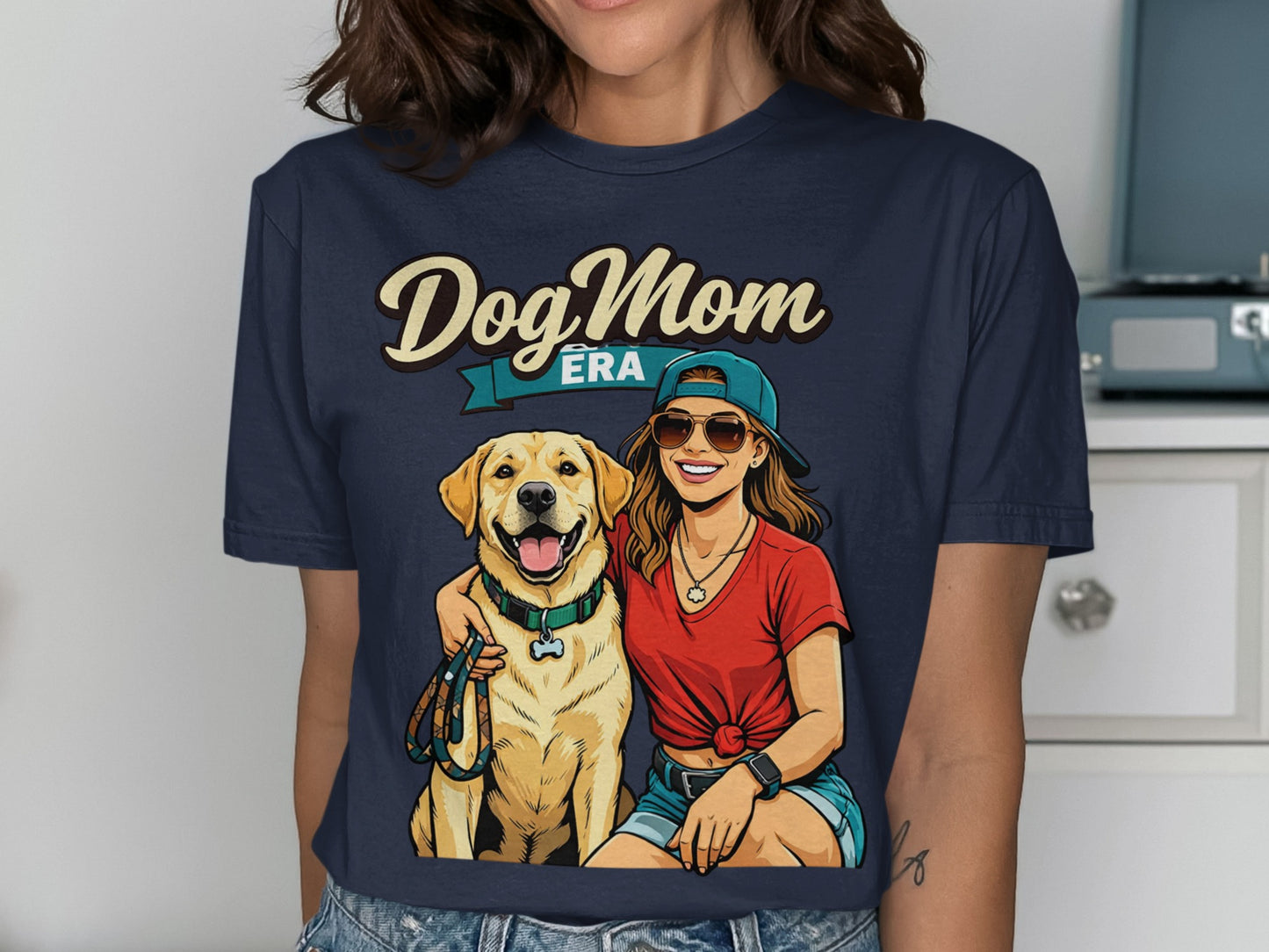 Dog Mom Era graphic on a navy t-shirt featuring a woman and a golden retriever.