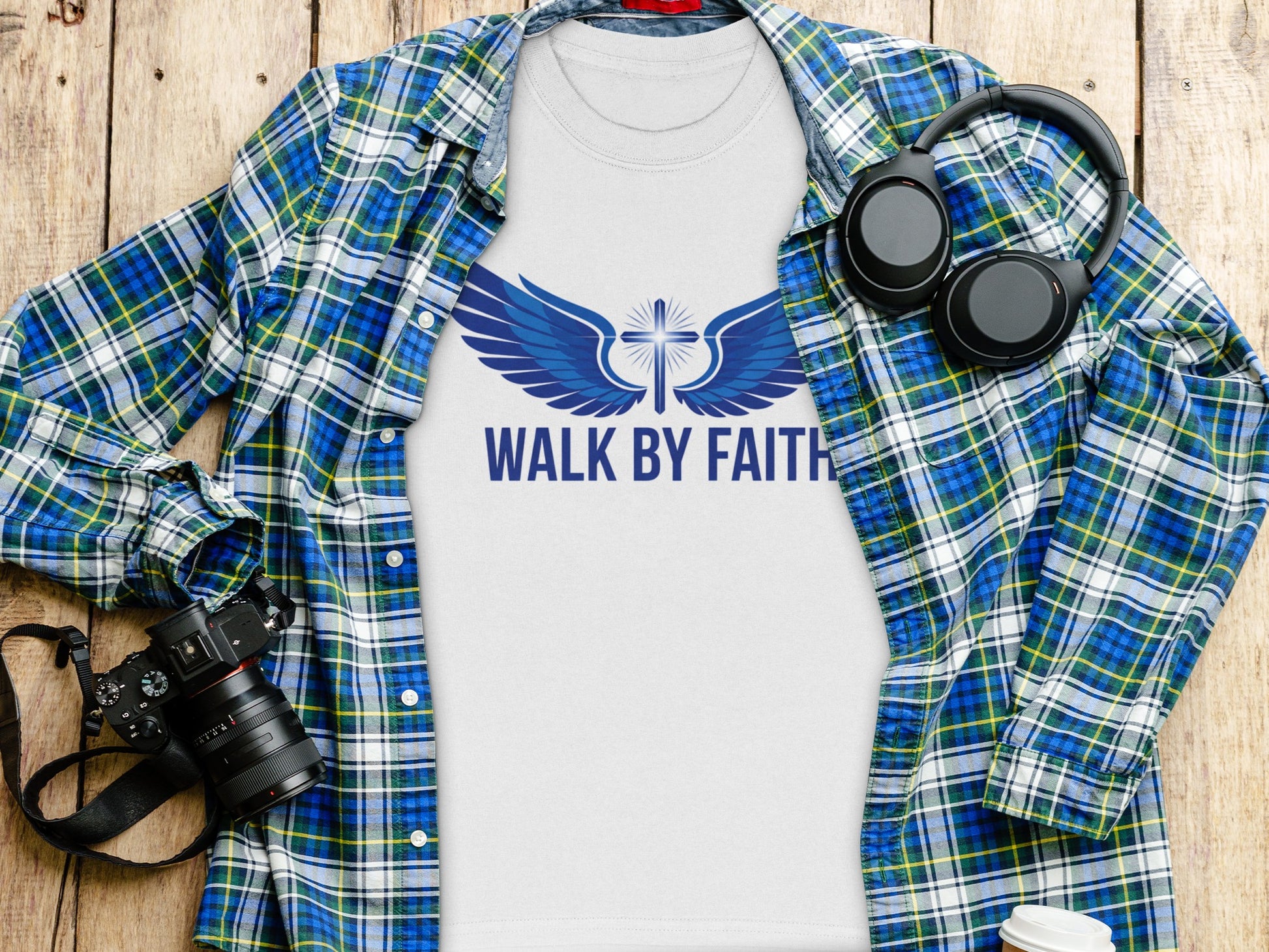 White t-shirt with blue wings and cross graphic, text "WALK BY FAITH".
