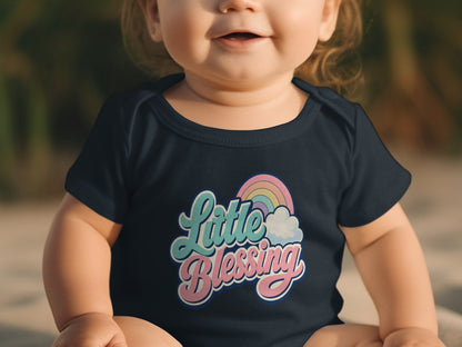 Baby in navy onesie with "Little Blessing" text and rainbow graphic.