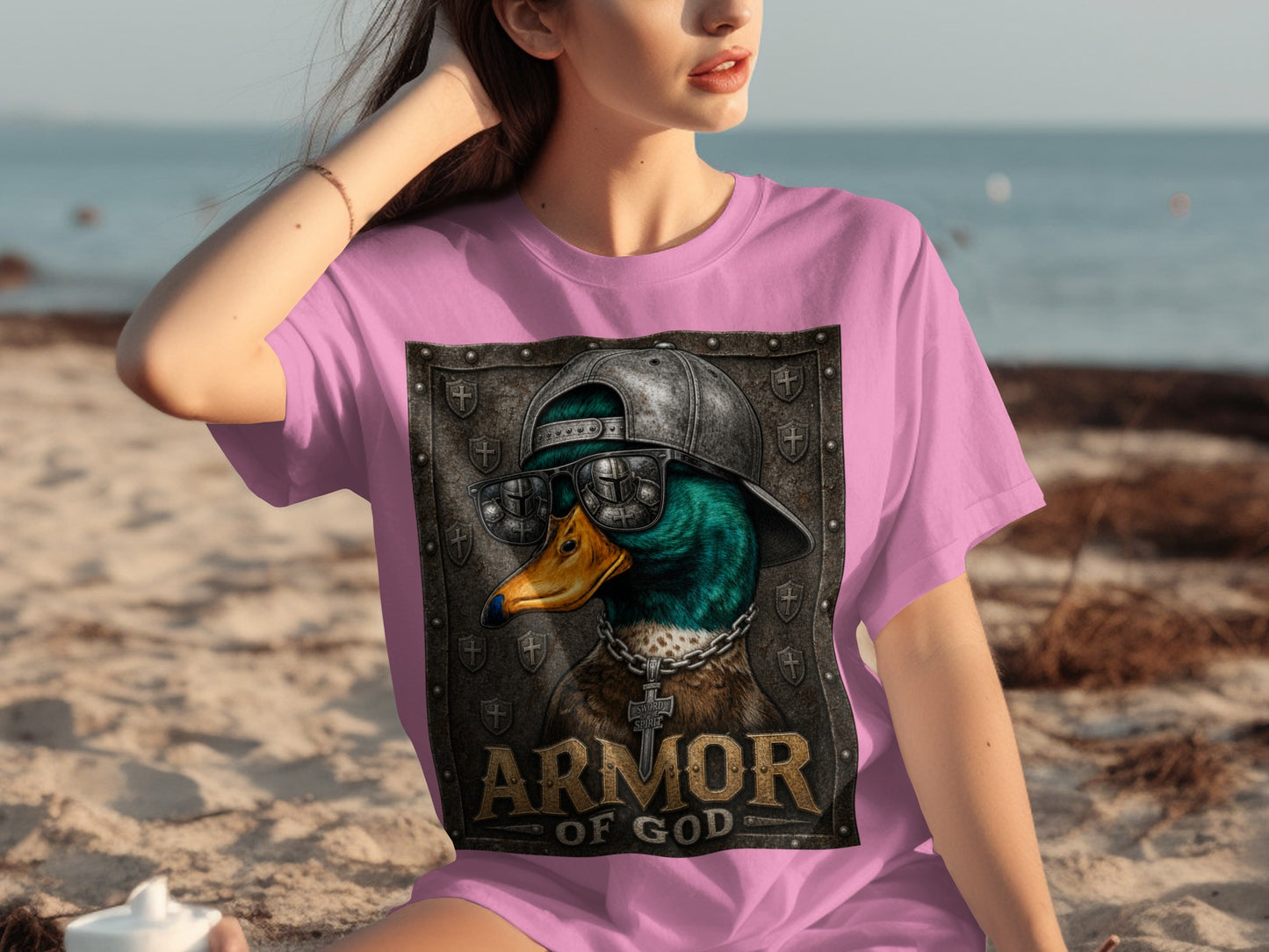 Pink t-shirt with a graphic of a duck wearing sunglasses, a chain, and the words "ARMOR OF GOD".