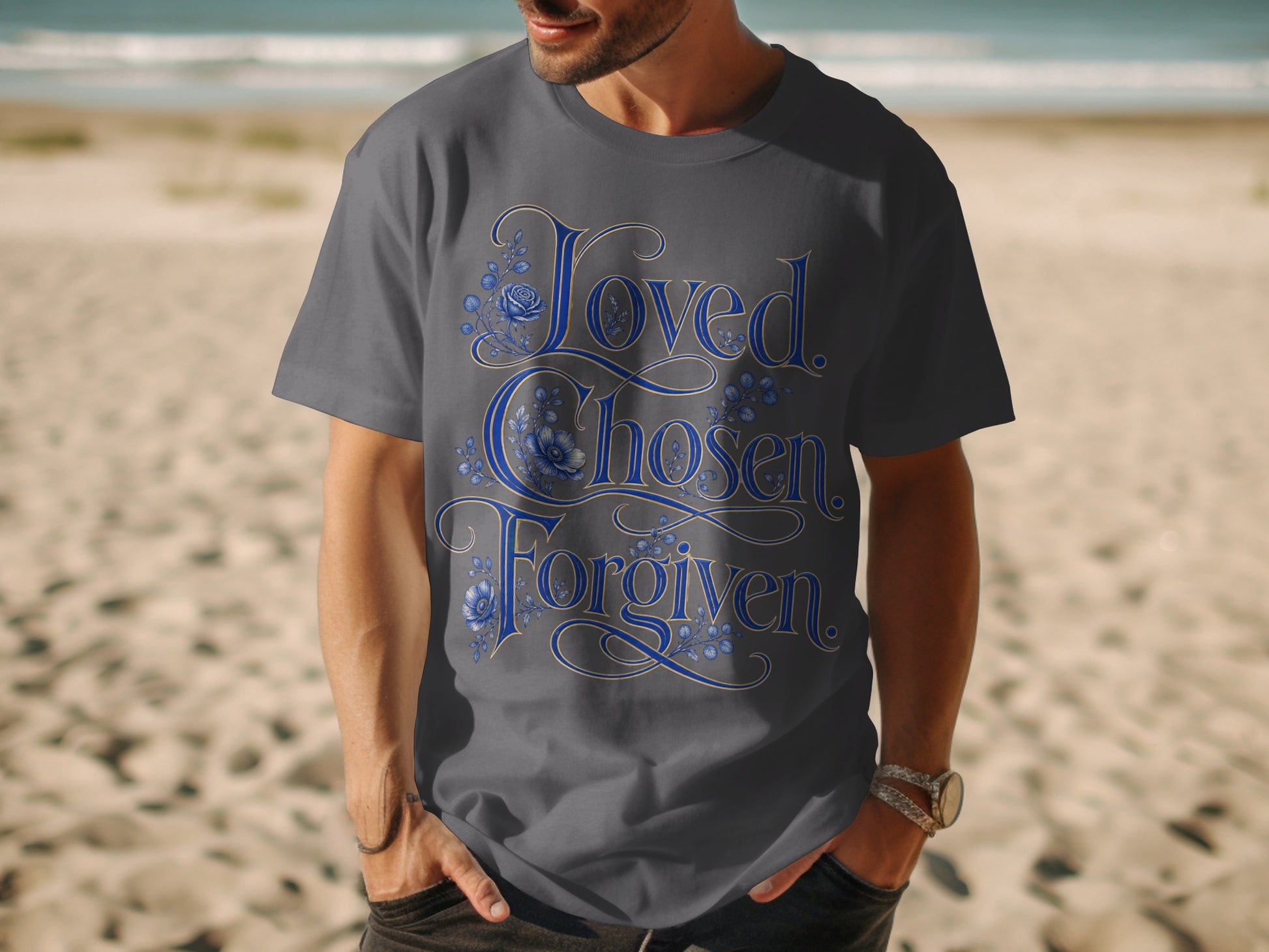 Dark gray t-shirt with "Loved. Chosen. Forgiven." text and blue floral accents.