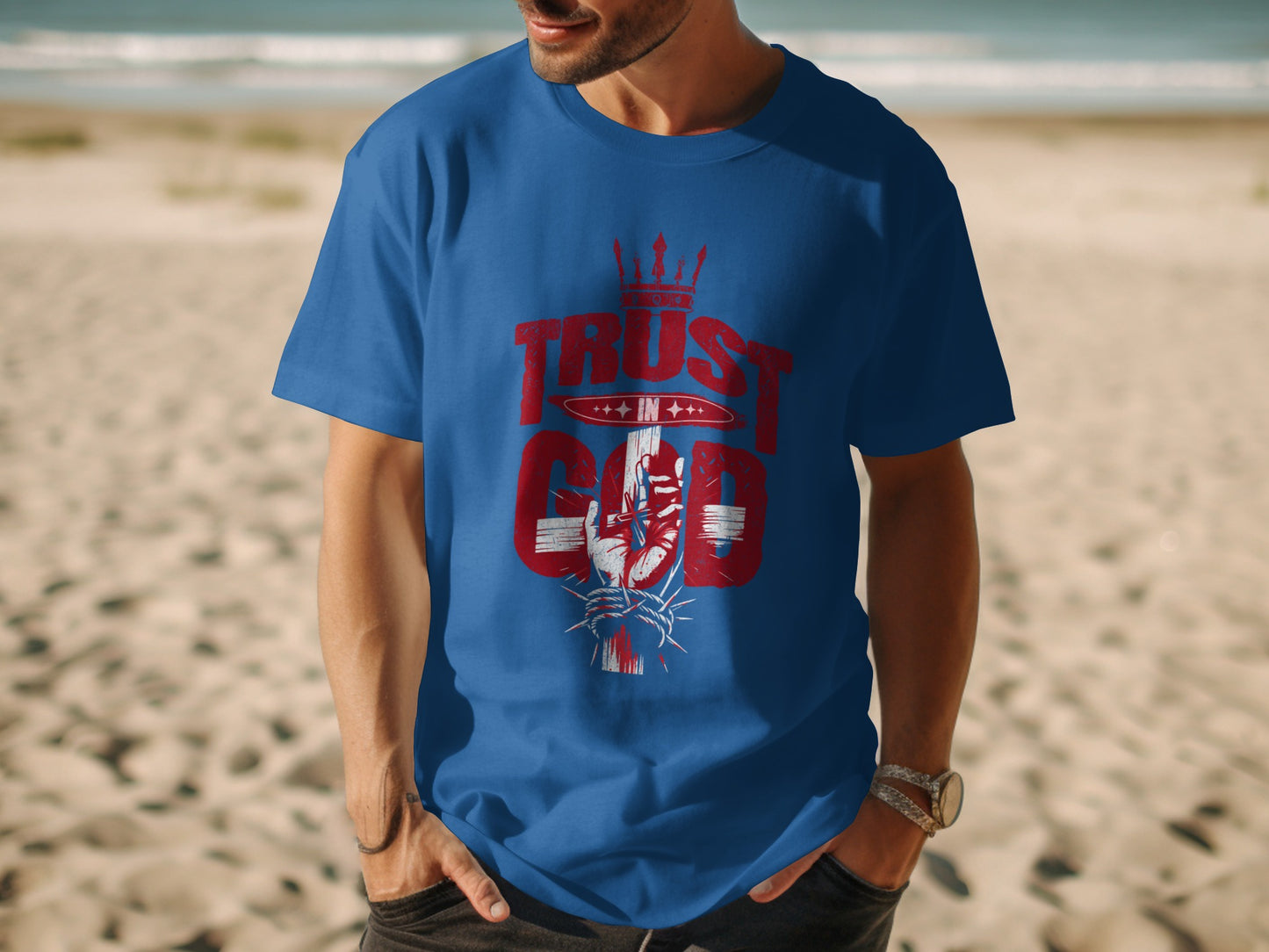 Blue t-shirt with "Trust in God" text and hand holding crown of thorns graphic.
