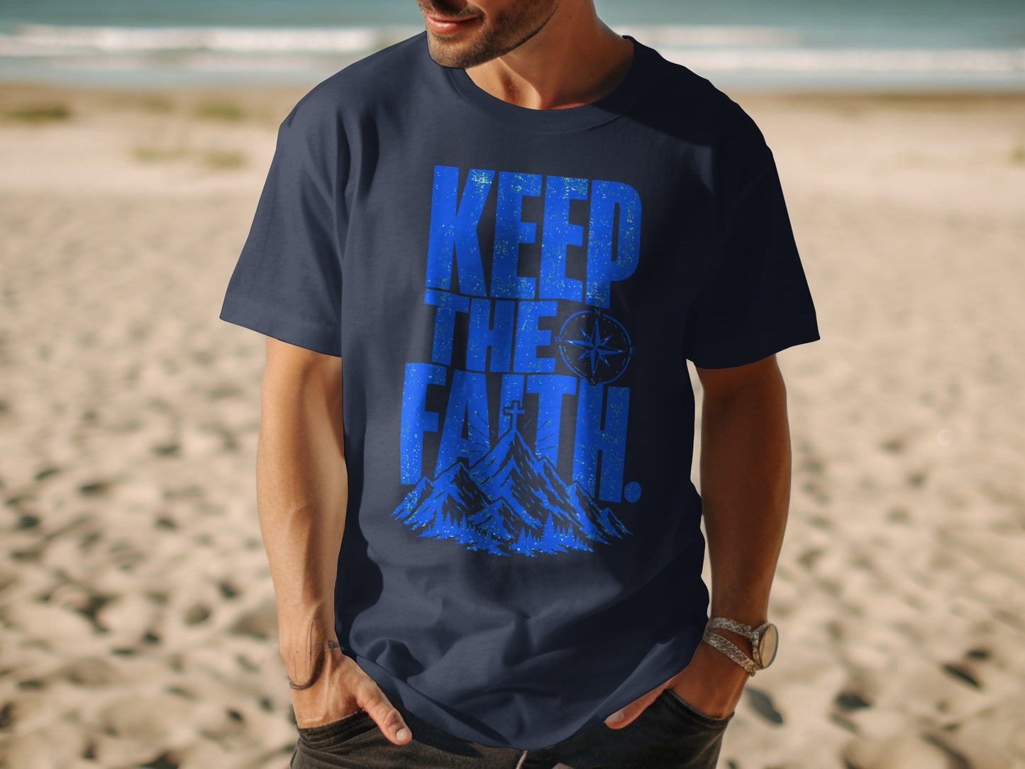 Navy t-shirt with blue "KEEP THE FAITH" text, compass, and mountains graphic.