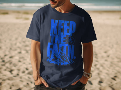 Navy t-shirt with blue "KEEP THE FAITH" text, compass, and mountains graphic.