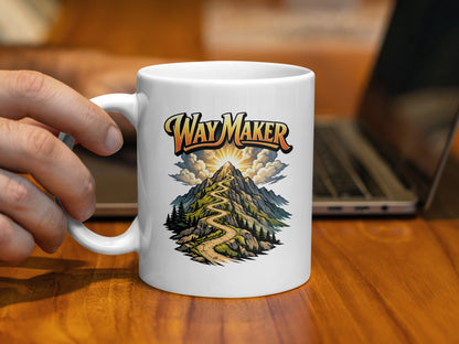 White mug with "Way Maker" text and mountain path illustration.