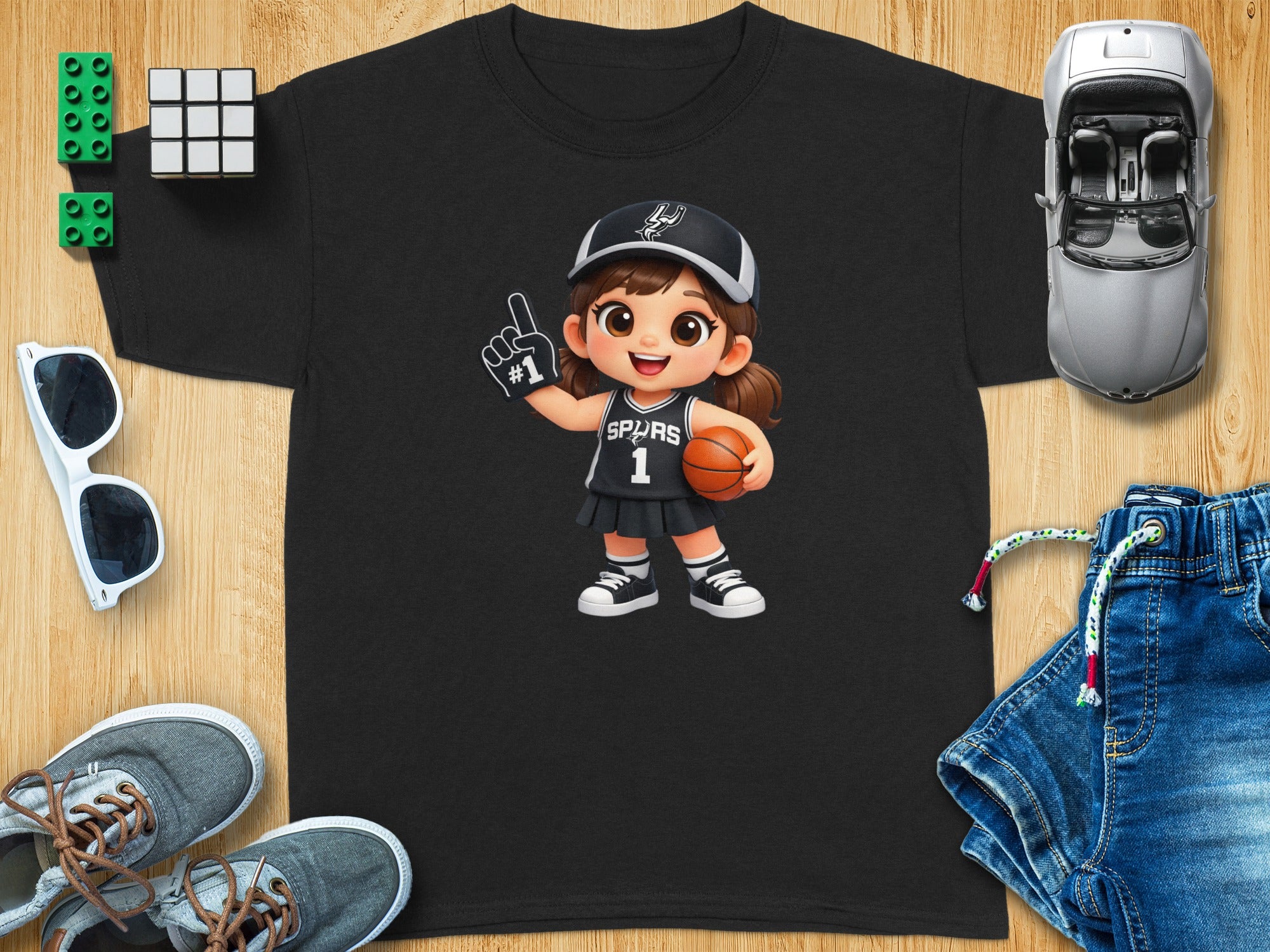 Black t-shirt with cartoon girl in Spurs #1 basketball uniform holding ball.