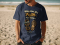 Navy t-shirt with "Walking by Faith, Not Sight" and boot prints.