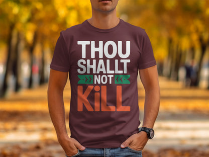Maroon t-shirt with white text "THOU SHALLT NOT KILL" and green graphic accents.