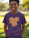 Kid wearing a purple t-shirt with "Kingdom Kid" text in orange and white.