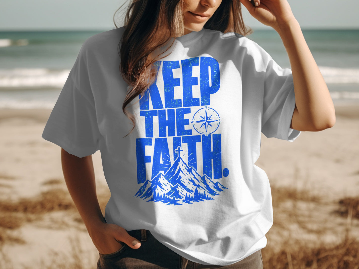White t-shirt with blue text "KEEP THE FAITH" and mountain graphic.