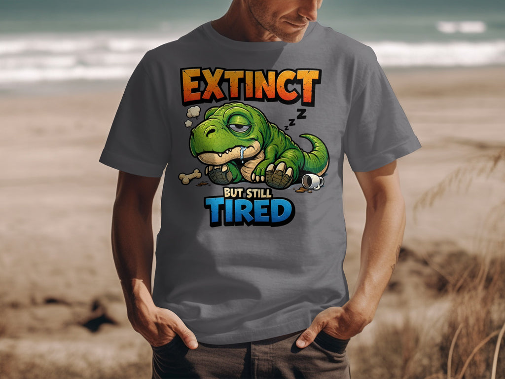 Gray t-shirt with a sleeping cartoon dinosaur and text "Extinct but still tired."