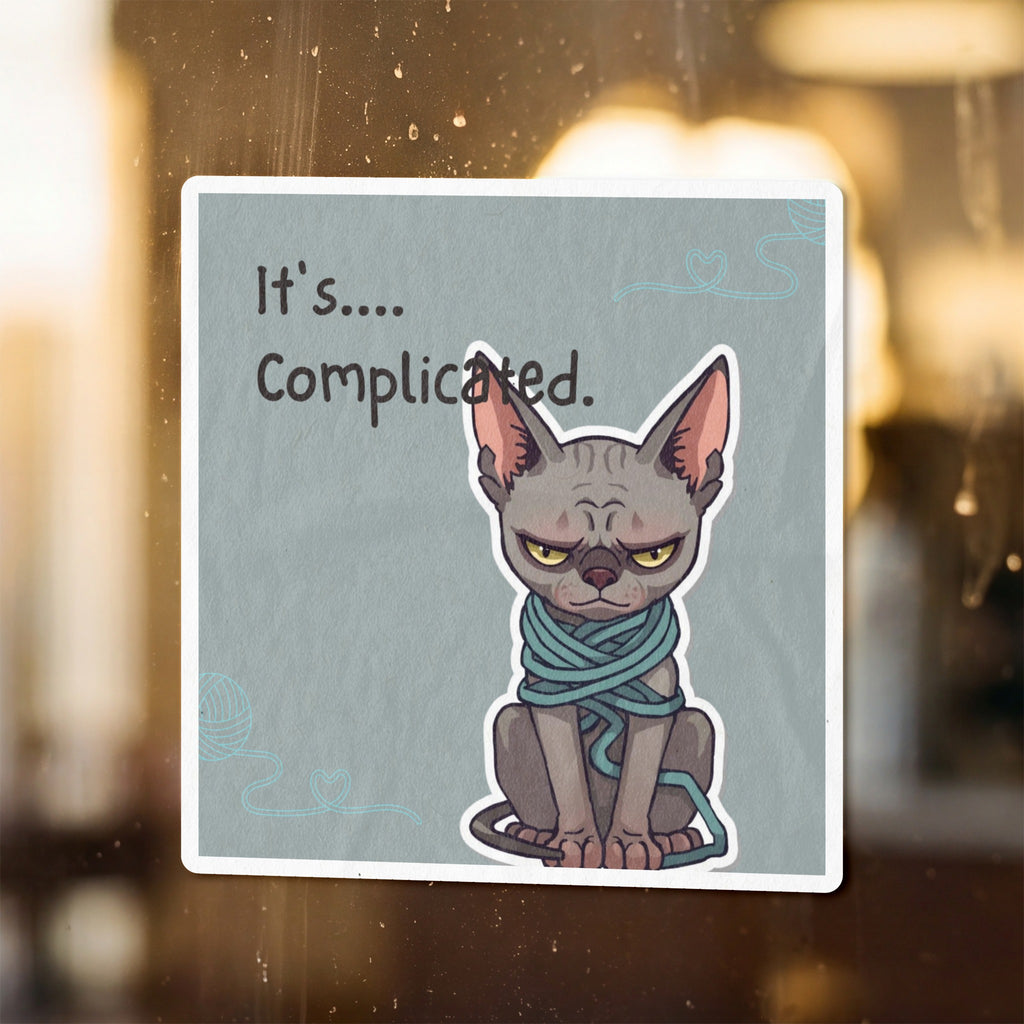A grumpy sphynx cat wrapped in teal yarn with text "It's.... Complicated."