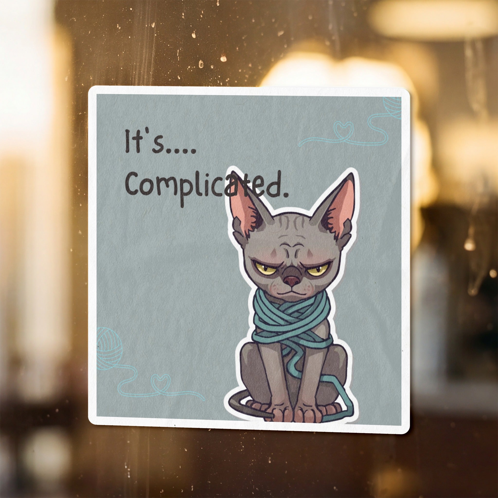 A grumpy sphynx cat wrapped in teal yarn with text "It's.... Complicated."