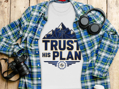 White t-shirt with a graphic that says "TRUST HIS PLAN" and a mountain cross design.