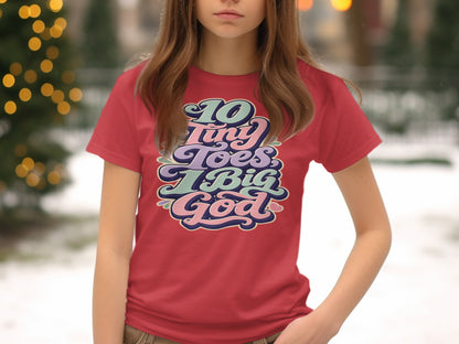 Red t-shirt with "10 Tiny Toes, 1 Big God" text in pastel retro lettering.