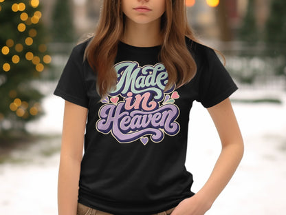 Black t-shirt with pastel lettering that reads "Made in Heaven."