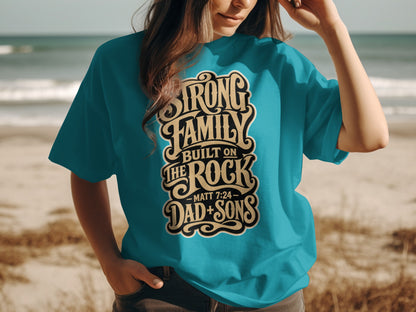 Teal t-shirt with "Strong Family Built On The Rock Dad + Sons - Matt 7:24" text.