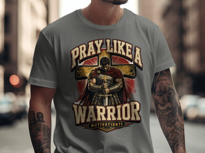 T-shirt graphic with warrior praying before a cross, text reads "Pray Like A Warrior".