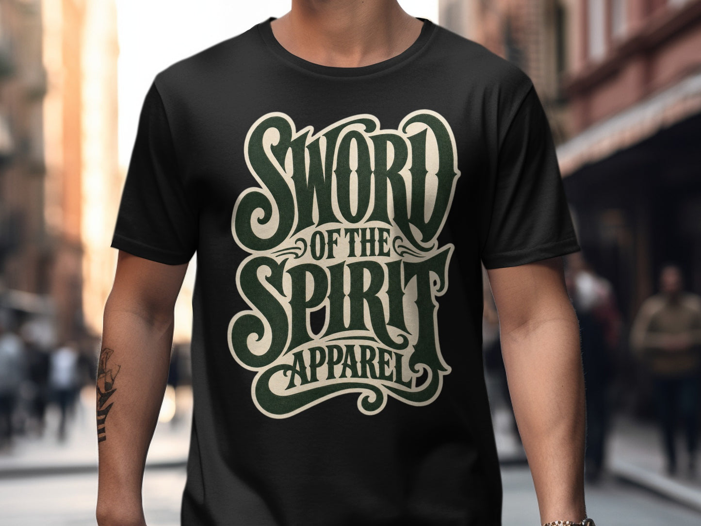 Black t-shirt with cream and green "Sword of the Spirit Apparel" text graphic.
