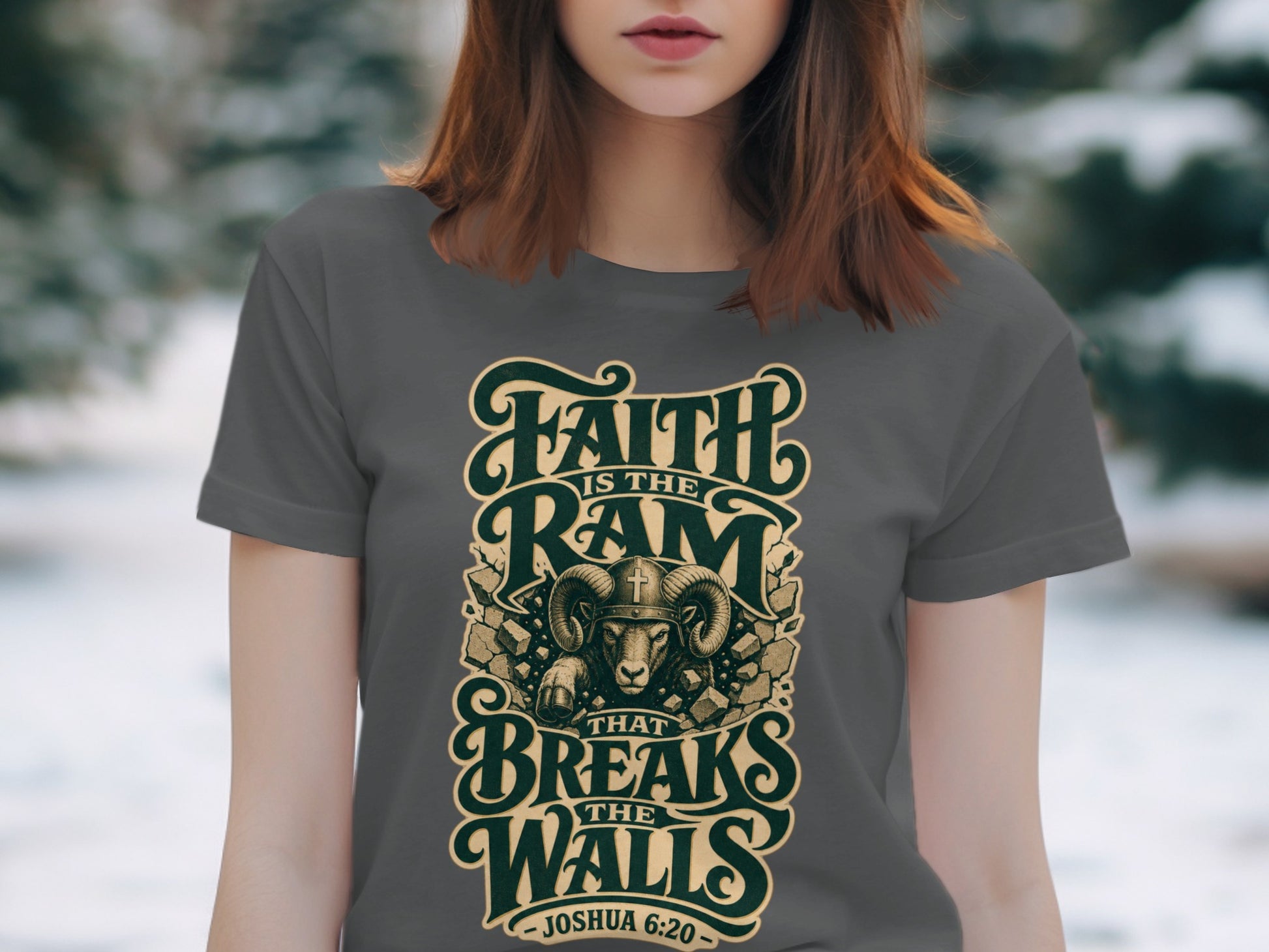 Grey t-shirt with "Faith is the Ram that Breaks the Walls - Joshua 6:20" text and ram illustration.