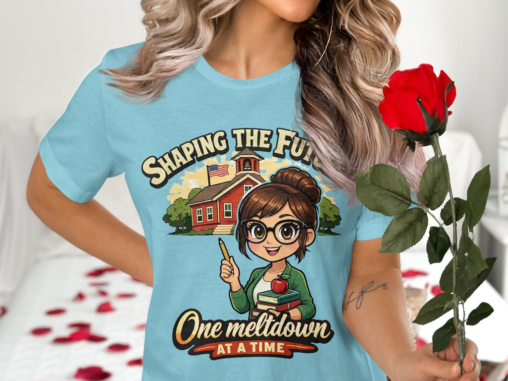 Light blue shirt graphic features a teacher with books and text.