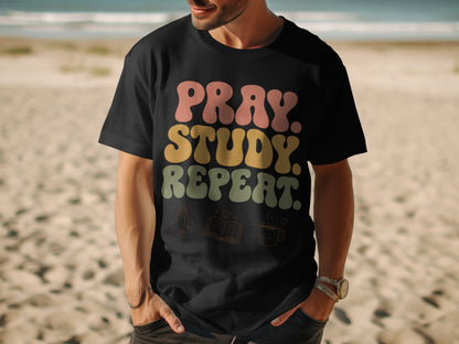 Black t-shirt with "PRAY. STUDY. REPEAT." text and graphic icons.