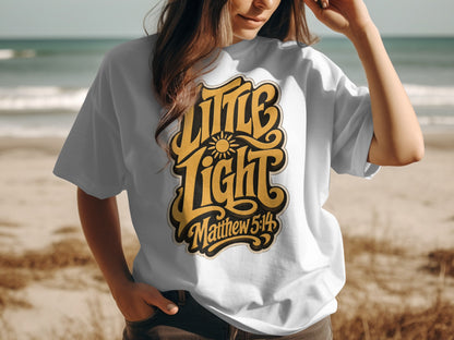 White t-shirt with yellow "Little Light Matthew 5:14" lettering and sun graphic