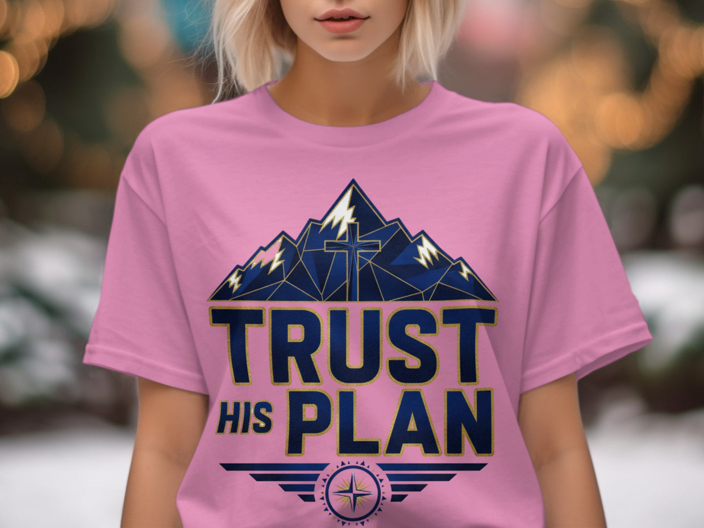Pink t-shirt with "TRUST HIS PLAN" text over a mountain and cross graphic.