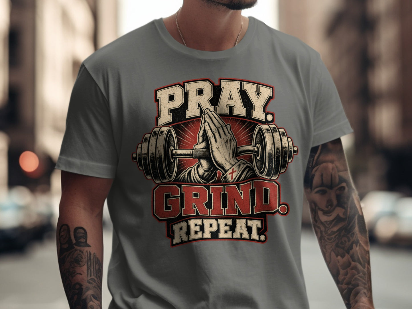 Gray t-shirt with Pray Grind Repeat text and barbell illustration.