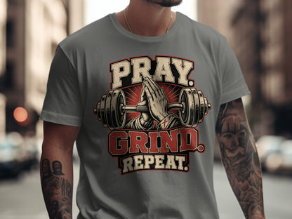 Gray t-shirt with Pray Grind Repeat text and barbell illustration.
